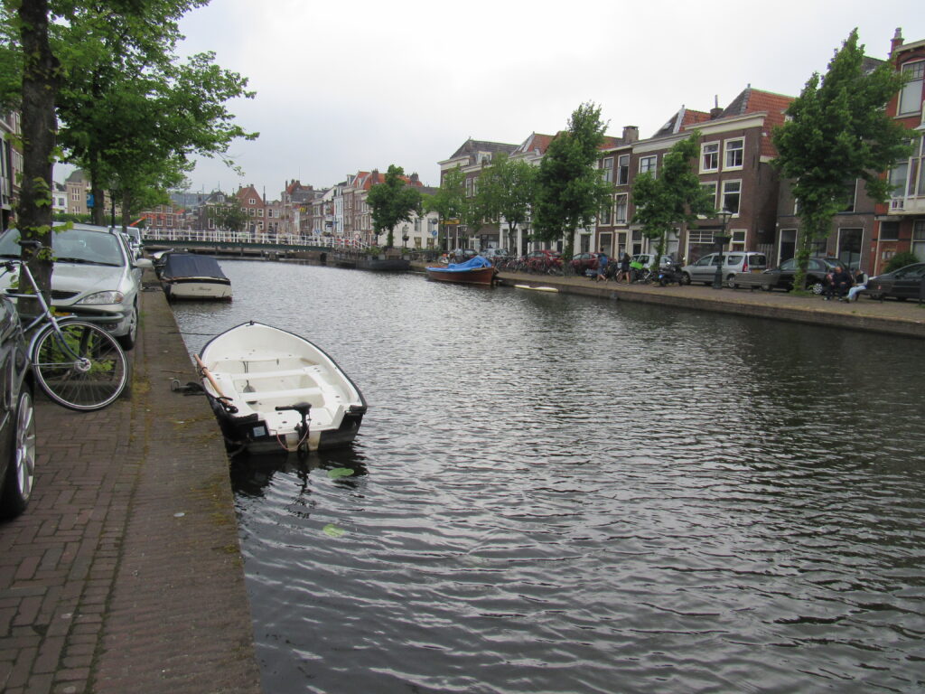 canal in Netherlands with boats and houses in background