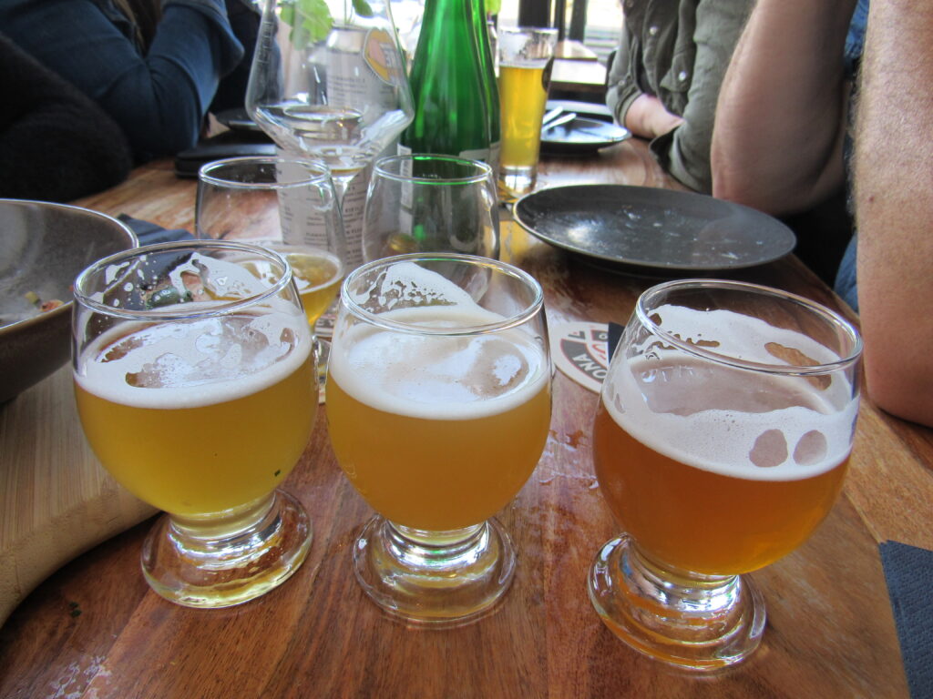 table with many half filled glasses of beer