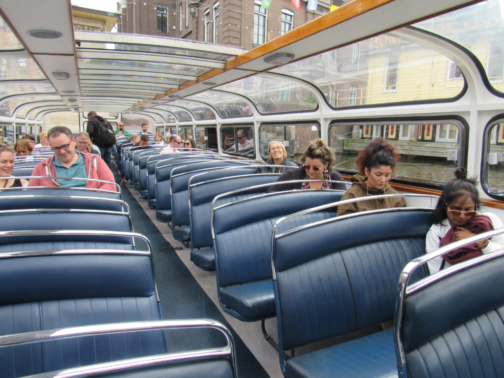 rows of blue seats inside a long tourist boar