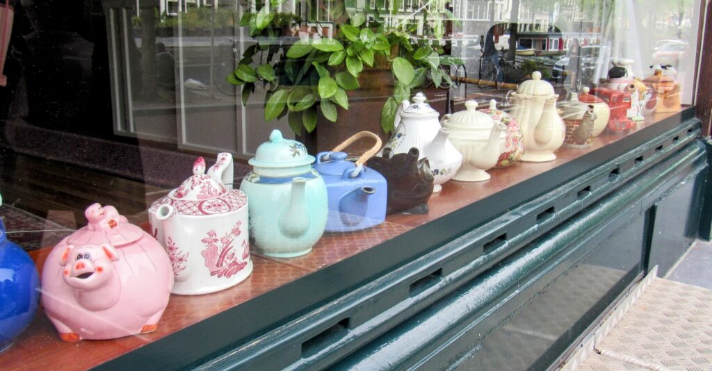 row of teapots in shop window