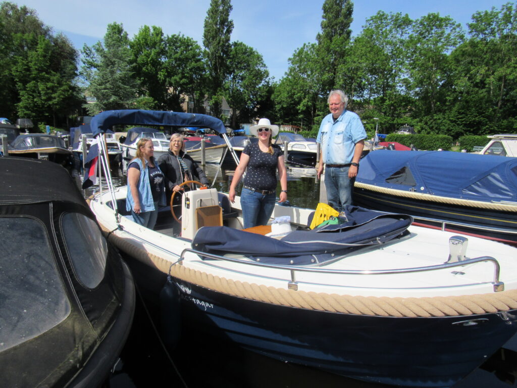 people standing around a small boat