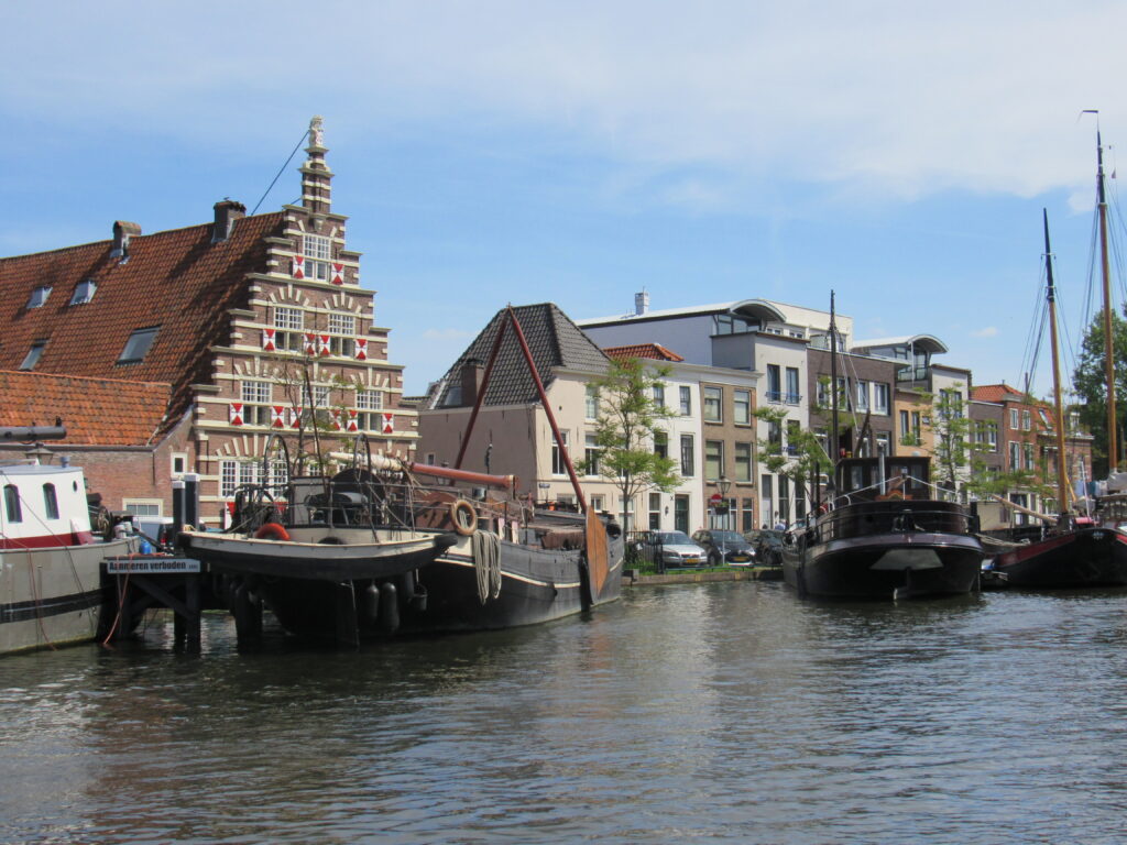 old building behind boats on waterfront