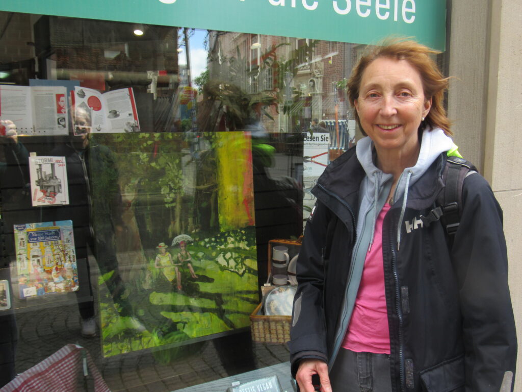 woman standing around in front of a painting 🎨 inside a shop window display