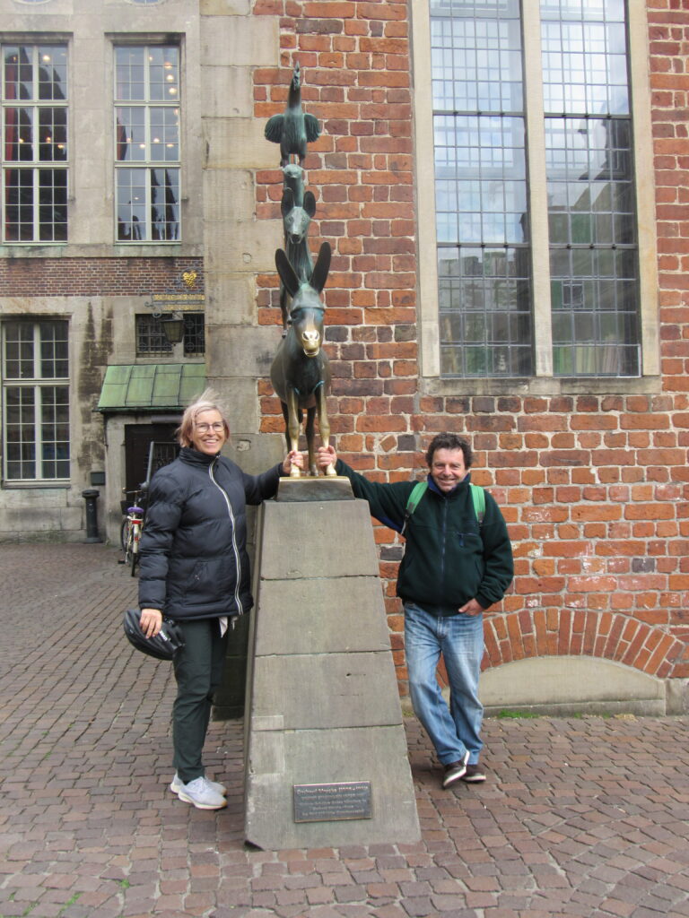 2 people standing beside statue