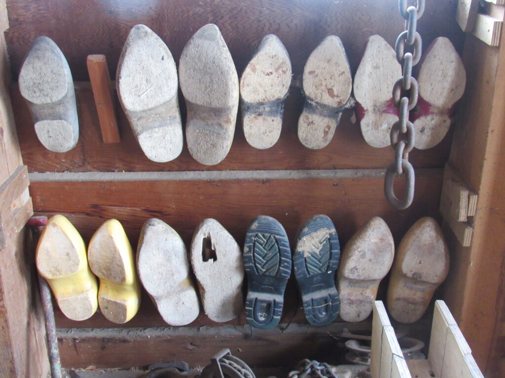 Rows of clogs hanging on a wall (not souvenirs)